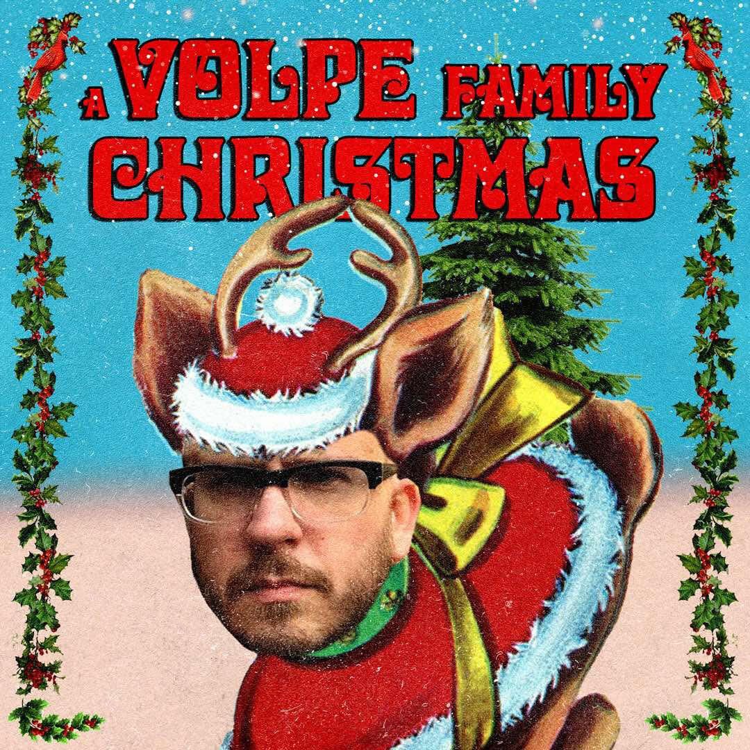 A human-reindeer hybrid abomination with Andrew Volpe’s face on it stands over red text that reads “a Volpe family Christmas”. A border of questionable birds and holly surrounds this monster.